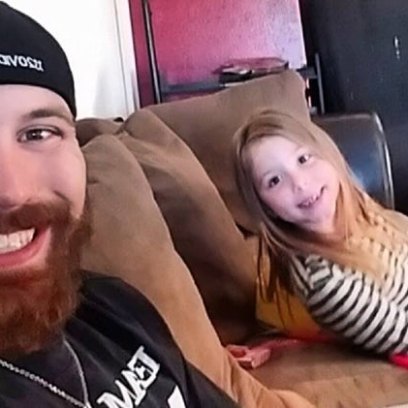 Adam Lind and daughter Aubree sitting on a couch