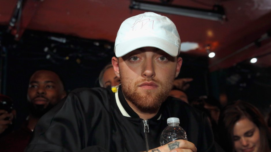 Mac Miller with a water bottle and white hat