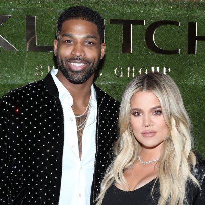 Khloe Kardashian wearing a black outfit with Tristan Thompson