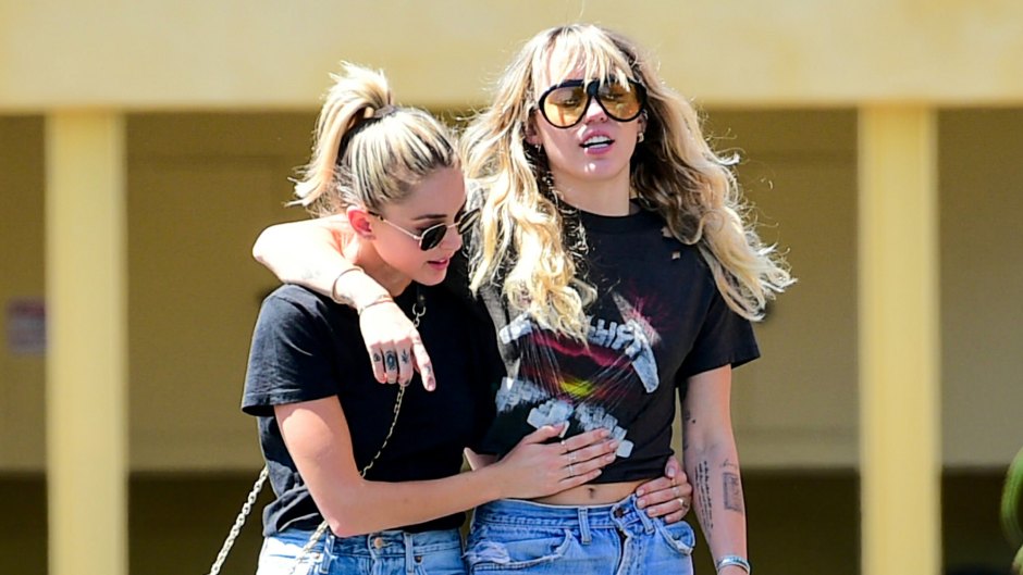 miley cyrus and kaitlynn carter both wear blue jeans and black t-shirts as they pack on the pda during out in los angeles miley cyrus and katilynn carter pack on pda