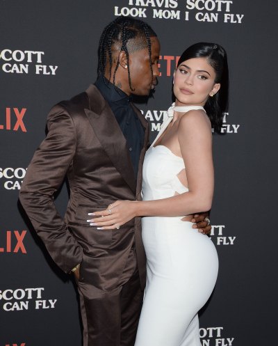 Kylie Jenner Wearing a White Dress With Travis Scott in a Brown Suit