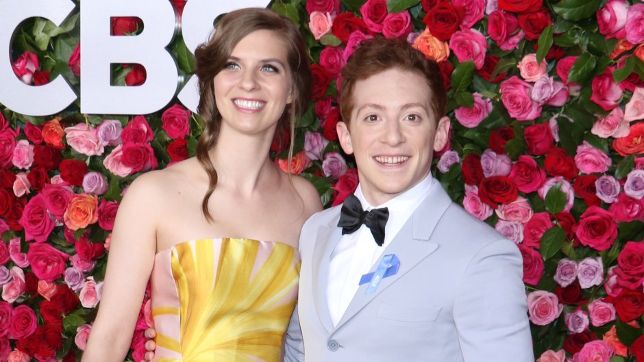 Ethan Slater wearing a pastel tuxedo and his wife, Lilly Jay, wearing a floral dress at the Tony Awards in 2018